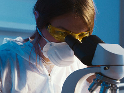 Woman working at a microscope